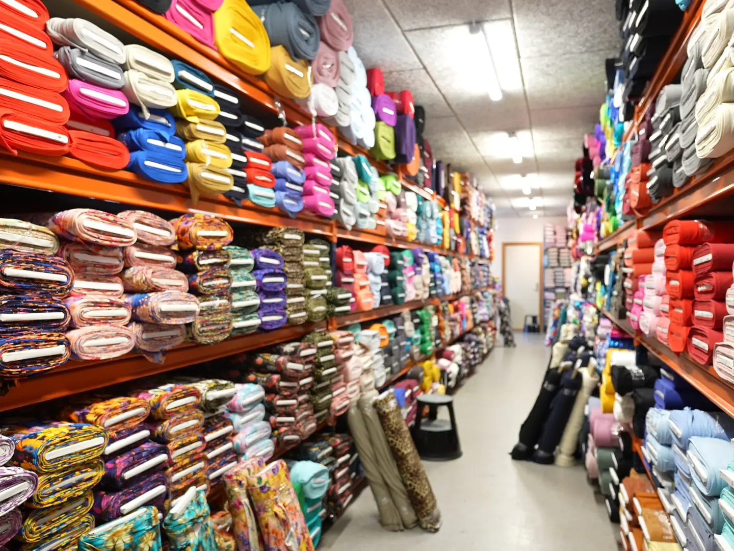 Fabric rolls on shelves in Jydsk Stoflager's warehouse at Jupitervej 2 in Ikast
