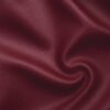 Soft faux leather in bordeaux laid in soft folds