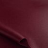 Close-up of the surface of soft faux leather in bordeaux