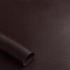 Close-up of the surface of soft faux leather in coffee