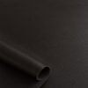 Close-up of the surface of soft faux leather in dark brown
