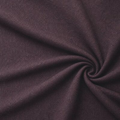 Textured upholstery fabric in aubergine laid in soft folds