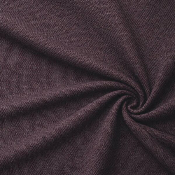 Textured upholstery fabric in aubergine laid in soft folds