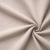 Textured upholstery fabric in beige laid in soft folds