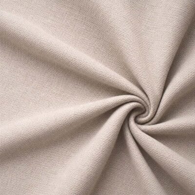 Textured upholstery fabric in beige laid in soft folds
