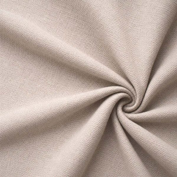 Textured upholstery fabric in beige laid in soft folds