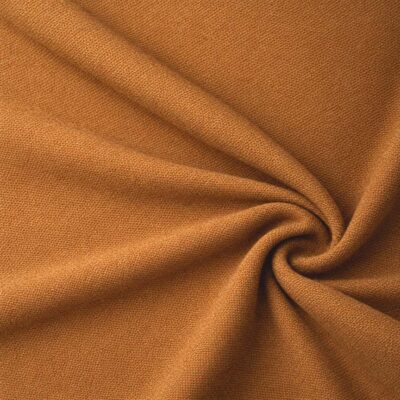 Textured upholstery fabric in cognac laid in soft folds