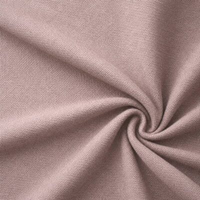 Textured upholstery fabric in dusky old pink laid in soft folds