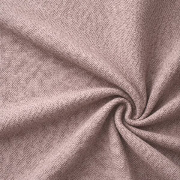 Textured upholstery fabric in dusky old pink laid in soft folds