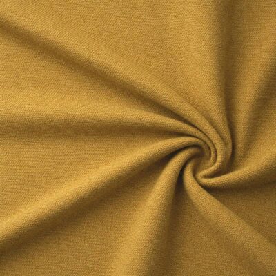 Textured upholstery fabric in ochre laid in soft folds