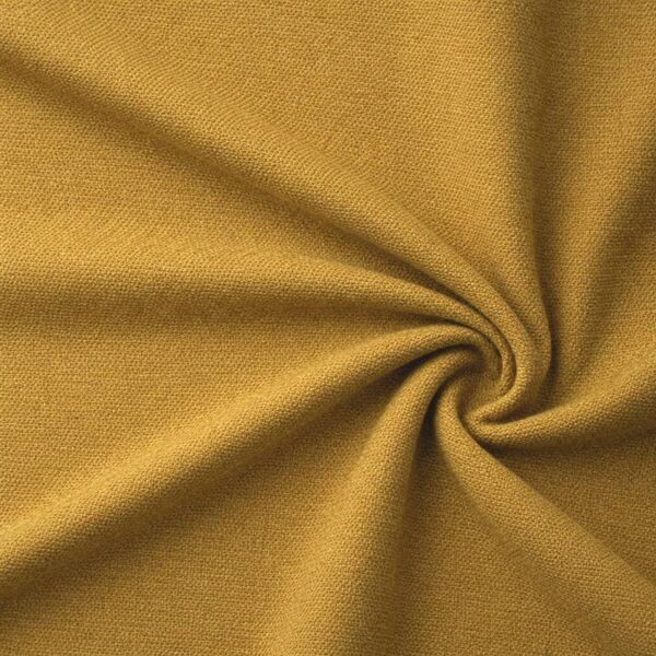 Textured upholstery fabric in ochre laid in soft folds