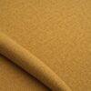 Close-up of the surface of textured upholstery fabric in ochre