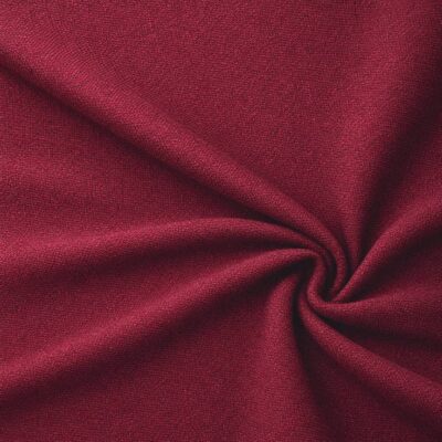 Textured upholstery fabric in red laid in soft folds