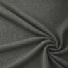 Textured upholstery fabric in forest green laid in soft folds