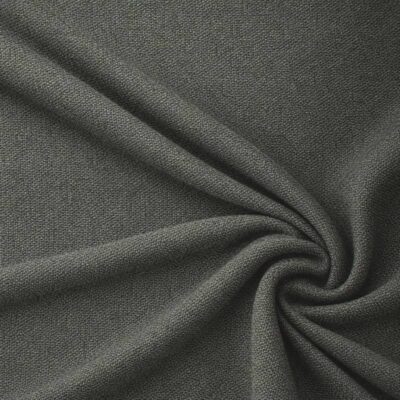 Textured upholstery fabric in forest green laid in soft folds