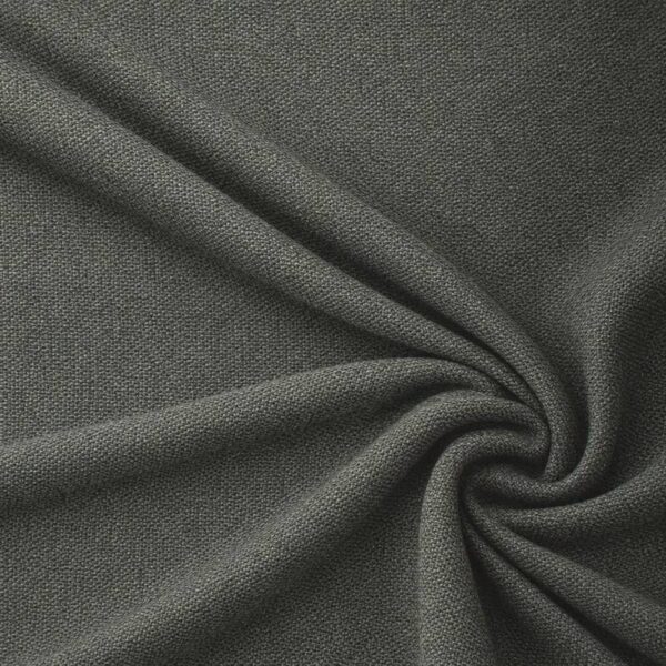 Textured upholstery fabric in forest green laid in soft folds