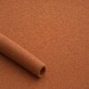 Close-up of the surface of textured upholstery fabric in terracotta