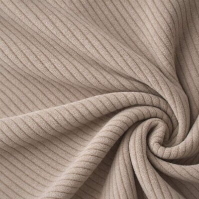 Corduroy upholstery velour in beige laid in soft folds