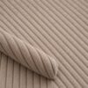 Close-up of the surface of corduroy upholstery velour in beige
