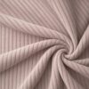 Corduroy upholstery velour in dusky old pink laid in soft folds