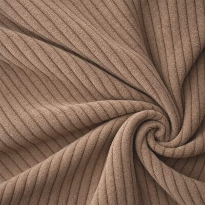 Corduroy upholstery velour in caramel laid in soft folds