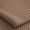 Close-up of the surface of corduroy upholstery velour in caramel