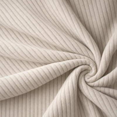 Corduroy upholstery velour in pearl white laid in soft folds