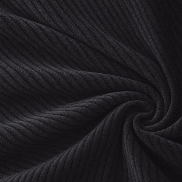 Corduroy upholstery velour in black laid in soft folds