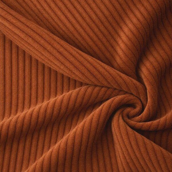 Corduroy upholstery velour in terracotta laid in soft folds