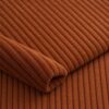 Close-up of the surface of corduroy upholstery velour in terracotta