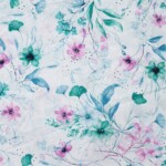 100% bomuld med broderi og forårsblomster i petrol, 145 cm bred