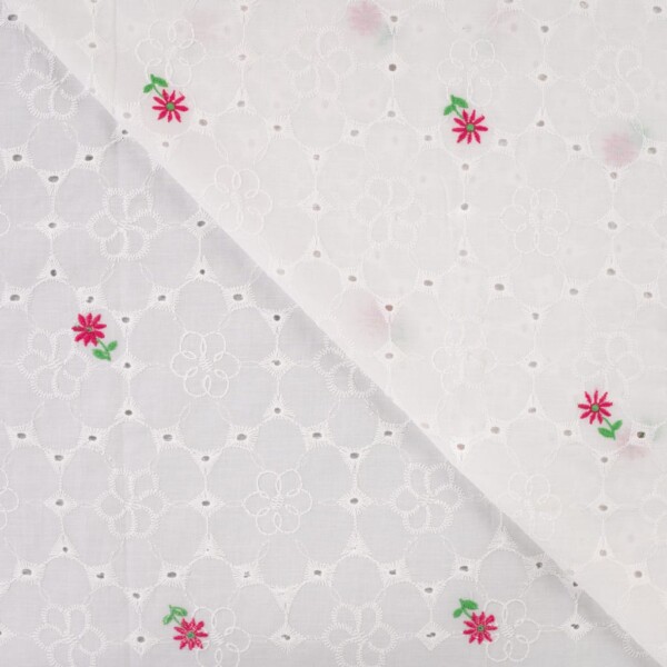 Close-up of floral embroidery on white woven cotton