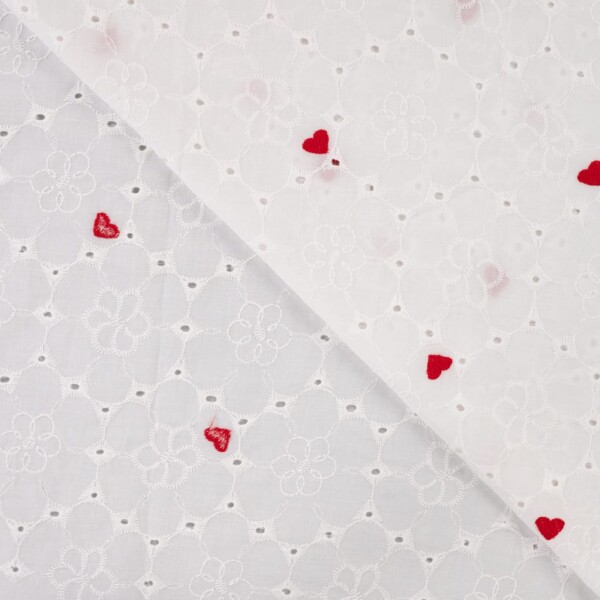 Close-up of heart motif in embroidery on white cotton