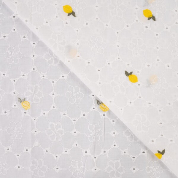 Close-up of lemon embroidery on white woven cotton