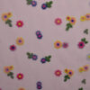 Lyserød mesh med blomster broderi i 100% polyester, 70 g/m²