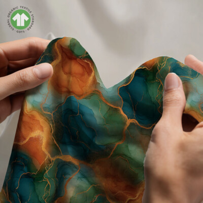 Detail of marble look on cotton jersey fabric in petrol and orange