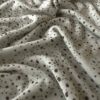 Sileä single jersey -pinta merinovilla-silkki neuloksessa pilkuilla