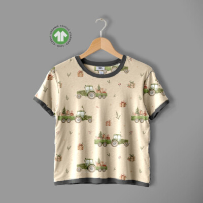 Detail of tractors and Christmas trees motif on taupe cotton jersey