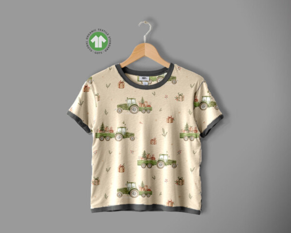 Detail of tractors and Christmas trees motif on taupe cotton jersey