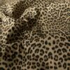 Taupe leopard stretch denim fabric close-up