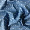 Denim med blomster på jeans bund close-up af motiv