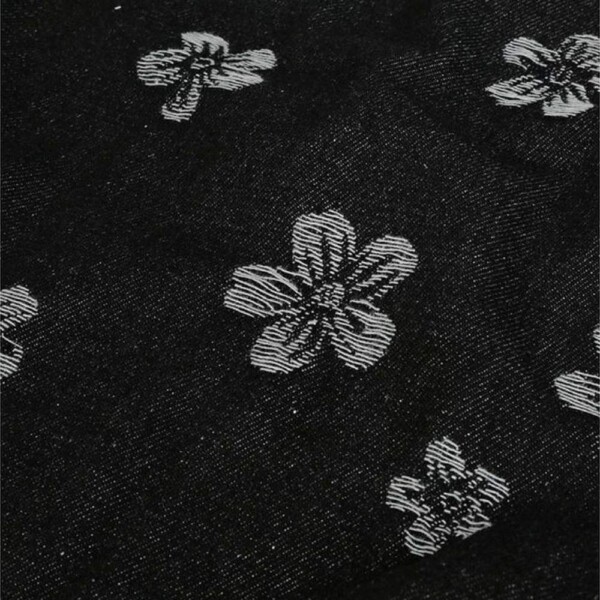 Close-up of flower motif in black denim jacquard, 150 cm wide