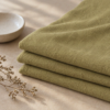 Curry Yellow merino wool jersey, folded in warm light
