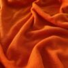 Brændt Orange merinould jersey, tæt på ribstrikkens struktur