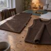 Brown teddy fabric sewn into a vest on a dining table