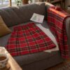 Skirt in red tartan wool being sewn on the sofa