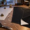 Black slub denim with fleece back being cut out