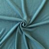 Aqua merino wool jersey fabric, twisted into a spiral to show drape