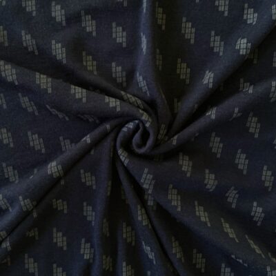 Navy Mosaic merino wool jersey fabric, twisted into a spiral to show drape
