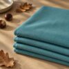 Aqua merino wool jersey fabric, folded in autumn light